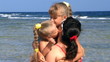 Mother with children on beach.