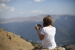 girl making photos with mobile to carpathian mountains range