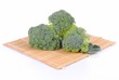 organic broccoli on a bamboo placemat, white background