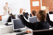 Photo: group of high school students hands up in computer class group of high school students hands up in computer class