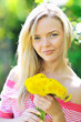 Young beautiful girl with dandelions