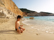 playful boy on the beach with sea on background