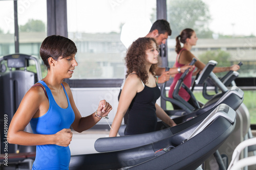 Photo: People Running on Treadmill in the Gym People Running on Treadmill in the Gym