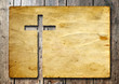 High resolution christian cross cut in an old paper on wood