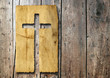 High resolution christian cross cut in an old paper on wood
