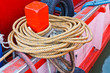 mooring rope tied around red wood anchor