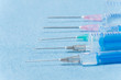 Hypodermic needles injections on blue medical cloth