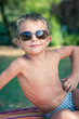 Funny boy outdoors portrait with sunglasses.