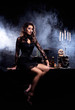 A sexy brunette woman on a dark and mystique background