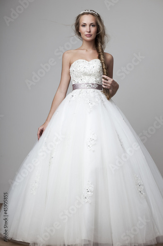 Photo: beautiful smiling girl in a white wedding dress beautiful smiling girl in a white wedding dress