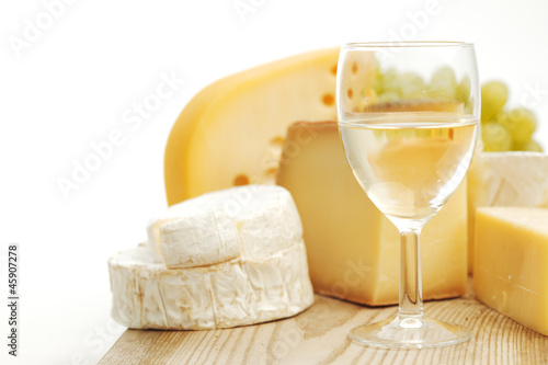 Photo: cheese and wine on a wooden table cheese and wine on a wooden table