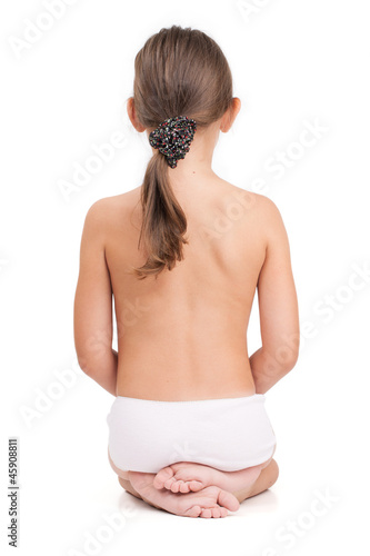 Photo: Nude little girl sitting back to us on a light background Nude little girl sitting back to us on a light background