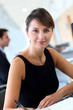 Businesswoman in office writing notes