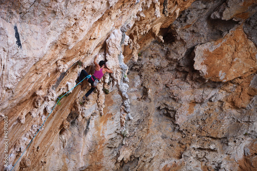 Photo: Female rock climber on a cliff face Female rock climber on a cliff face