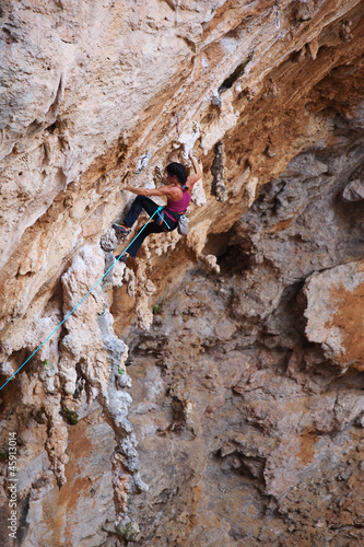 Photo: Female rock climber on a cliff face Female rock climber on a cliff face
