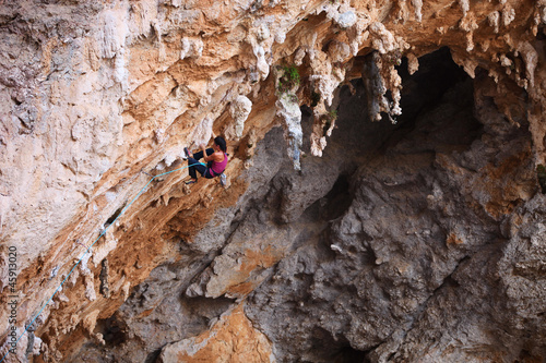 Photo: Female rock climber on a cliff face Female rock climber on a cliff face