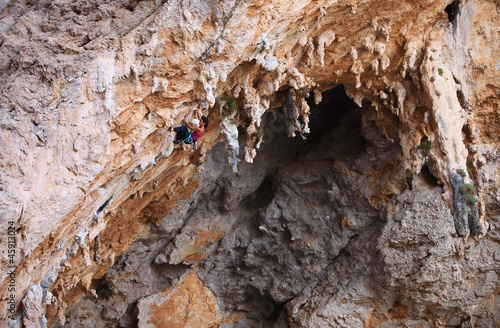 Photo: Female rock climber on a cliff face Female rock climber on a cliff face