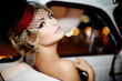 beautiful fashion girl in retro style sitting in old car