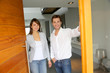 Couple opening the front door of their home