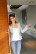 Woman opening her house door to welcome people