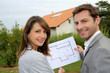 Couple looking at their new built house