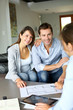 Couple meeting architect for plans of future home