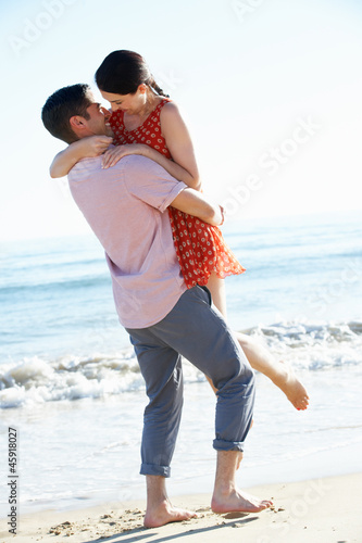 Photo: Couple Enjoying Romantic Beach Holiday Couple Enjoying Romantic Beach Holiday