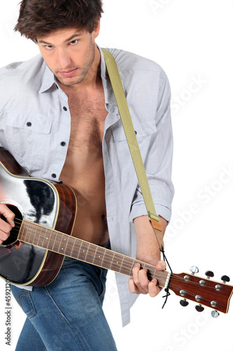 Photo: Man playing the guitar on white background Man playing the guitar on white background