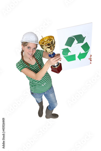 Photo: A female construction worker first in recycling. A female construction worker first in recycling.