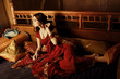 beautiful indian woman laying in ethnic interior