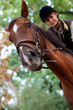 Young woman riding a horse