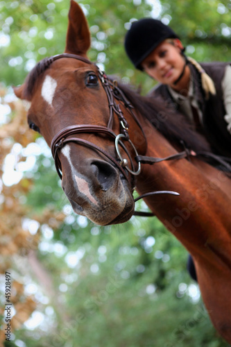 Photo: Young woman riding a horse Young woman riding a horse