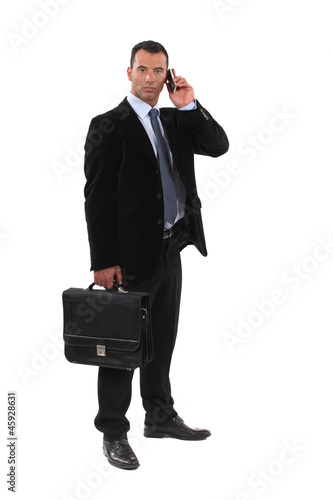 Photo: Serious businessmen with a cellphone Serious businessmen with a cellphone