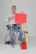 Carpenter holding a blank red sign