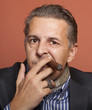 Man wearing suit gangster style smoking cigar