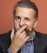 Man wearing suit gangster style smoking cigar
