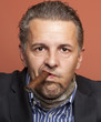 Man wearing suit gangster style smoking cigar