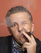 Man wearing suit gangster style smoking cigar