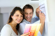 Couple choosing paint colour for their new home