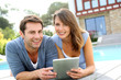 Couple websurfing on internet with tablet
