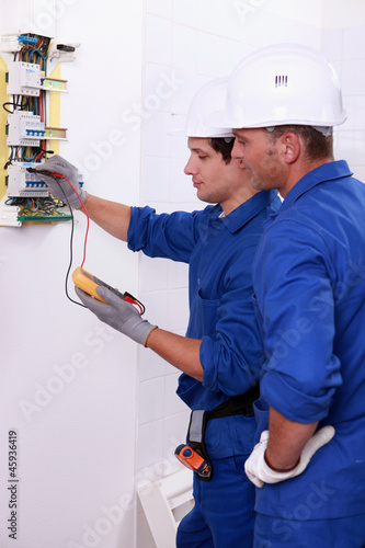 Photo: Two electricians performing checks Two electricians performing checks