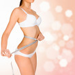 Foto: Woman taking measurements of her body Woman taking measurements of her body