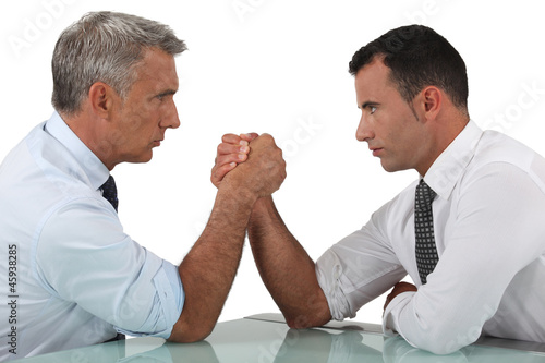 Photo: businessmen arm wrestling businessmen arm wrestling