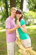 Husband hold hands of wife near braided straw