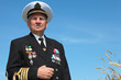 Grandfather in form, cap, ordens, medals pose background sky
