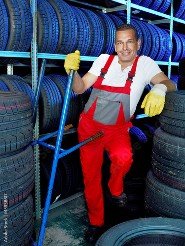 Photo: Car mechanic stores winter tires for tire changing Car mechanic stores winter tires for tire changing