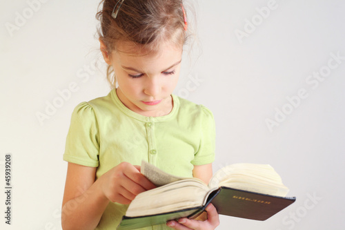 Photo: Little girl read bible Little girl read bible