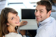 Upper view of smiling couple using laptop computer