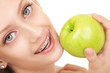 Cute girl in braces with green apple on white background