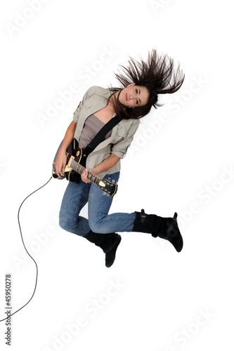 Photo: Young woman playing the electric guitar Young woman playing the electric guitar